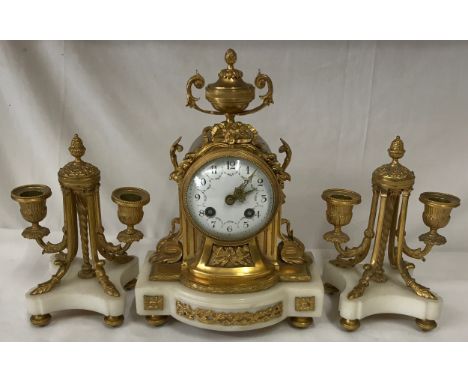 A French style white marble and gilt metal clock garniture with white enamel face,30cms high. 