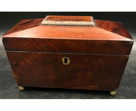 A mahogany sarcophagus caddy with key and two interior lidded compartments on ball feet. 13 d x 22.5 w x 14cm h. 