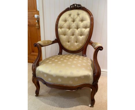 A 19thC walnut button backed upholstered ladies chair on cabriole legs and ribbon carving to top. 