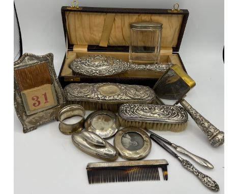 A quantity of silver to include boxed hairbrush, clothes brushes, napkin ring, nail buffer, comb, desk calendar, magnifying g