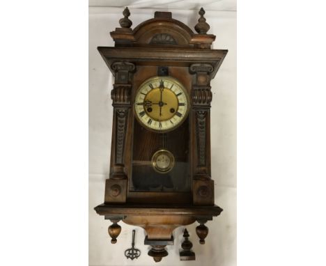 A wall clock with R A marked on pendulum with key. Approx. 60 h x 16 d x 30cm w. 