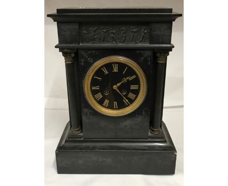 A Victorian slate mantle clock with column supports. With pendulum. 