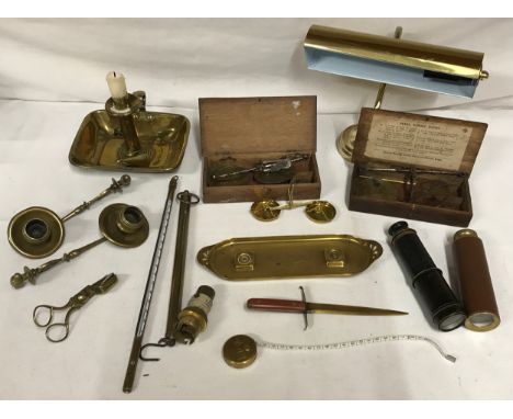 A selection of brass items to include chamber stick, three coin balances, pen tray, letter opener, two mono telescopes, two w