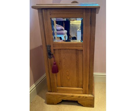 A pine pot cupboard, bevel edged mirror to door front with shelf to interior. 75 h x 41 w x 33cm. 