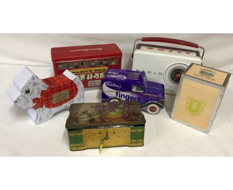 A collection of tins to include a Cadbury's fingers mini van, mini Scottie dog shortbread, M&amp;S party bus, one in shape of