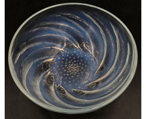 A Lalique 'Poissons' opalescent glass dish,moulded with fish, etched mark 'R. Lalique France'. No 3212 21cm diameter. 