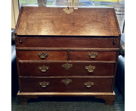 A 18thC oak bureau on bracket feet with fitted interior and lidded compartment. 104 h x 59 d x 97cm w.