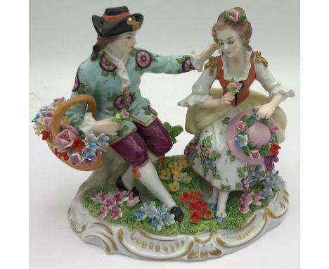 A Sitzendorf figure of a couple sitting together with flowers 