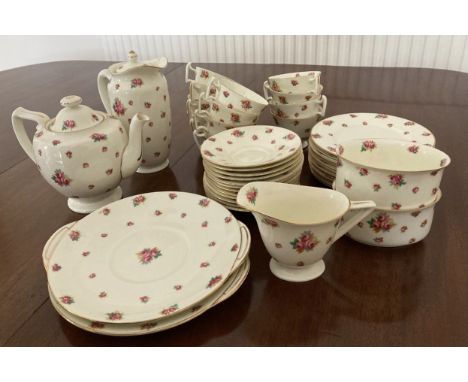 A Royal Doulton tea service with rose pattern and gilt edges comprising: 12 x cups and saucers, teapot, water jug, milk jug, 