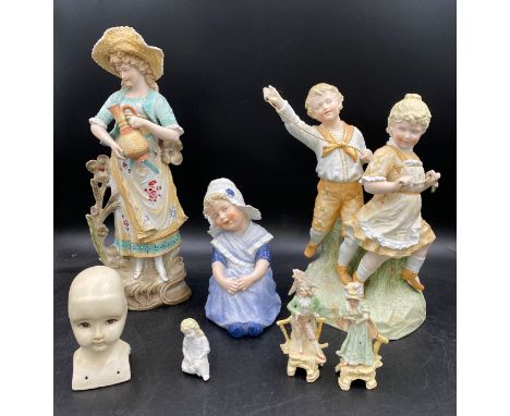 A collection of bisque figures, some in the style of Gebruder Heubach to include a pair of children playing a rope game 30cm 