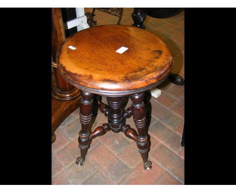 An antique revolving piano stool