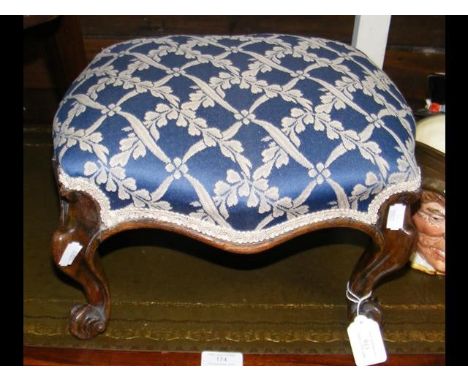 A small Victorian stool on cabriole supports