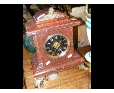 A rouge marble cased striking mantle clock 