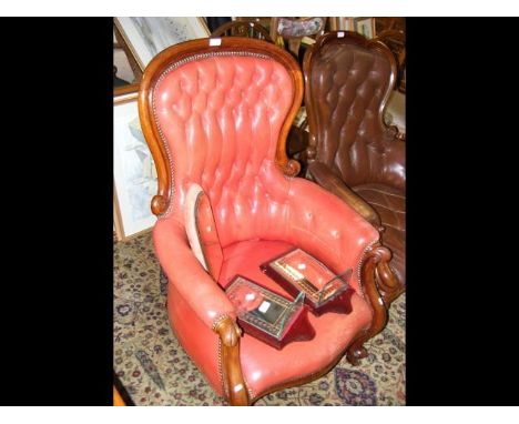 A Victorian mahogany framed library armchair with button back red leather upholstery