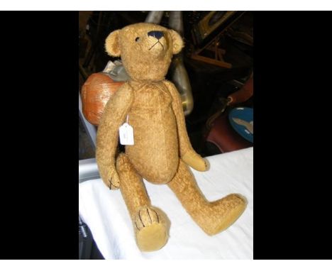 An antique straw filled teddy bear having Steiff button to ear and growler - 58cm