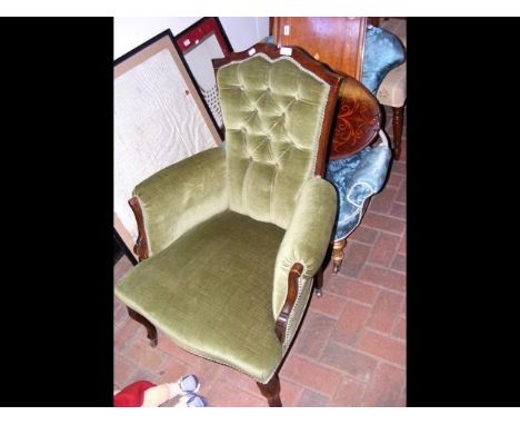 An Edwardian armchair with button back