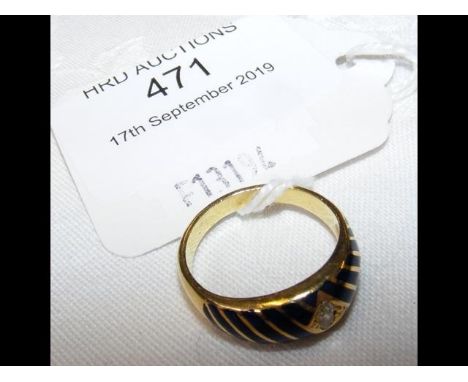 A diamond ring with blue enamel inlay in yellow metal setting