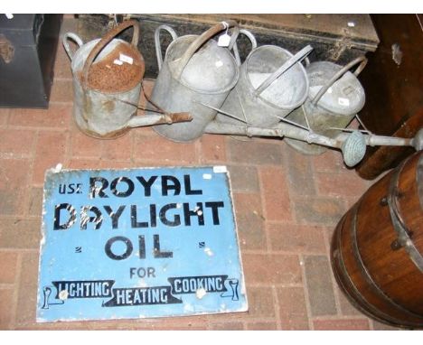 Four galvanised watering cans, together with an old enamel sign