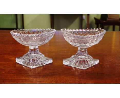 Two Georgian cut crystal salts with lemon squeezer bases, 8cm high approx