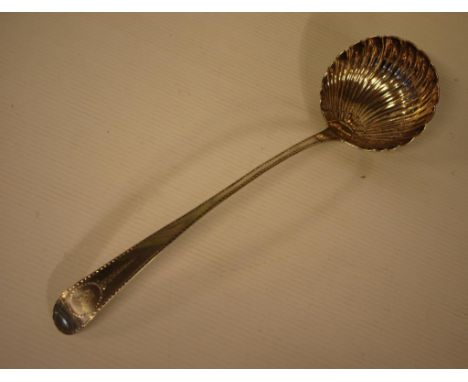 George III Irish sterling silver soup ladle with a shell-shaped bowl and bright-cut handle, crested, hallmarked Dublin 1777 (
