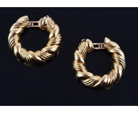 A pair of gold ear hoops by Van Cleef & Arpels, the polished and reeded ropetwist style hoops, with clip fittings, signed VCA