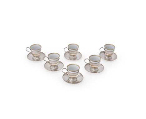 Cartier, a set of six plain silver and porcelain demitasse coffee cups and saucers, stamped Cartier Sterling, probably Americ