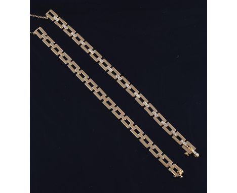 A gold coloured diamond bracelet by M. Gérard, the polished pierced rectangular links with brilliant cut diamond set baton li