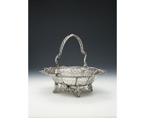 A George III silver swing handled basket by William Plummer, London 1765, with a pierced lattice loop handle, a shaped gadroo