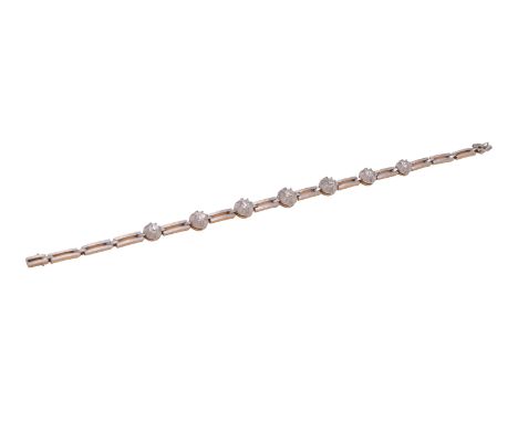 An early 20th century diamond bracelet, the striated pierced baton links with cut down collet set old brilliant cut diamond s