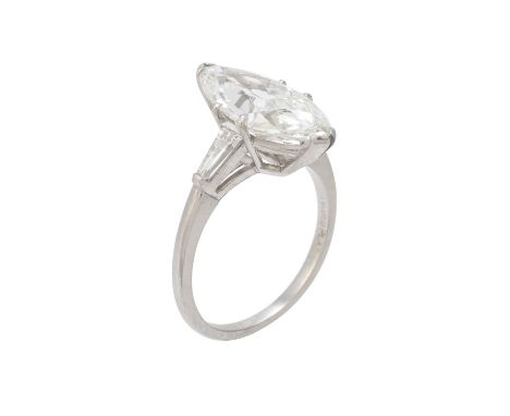 A single stone diamond ring, the marquise cut diamond weighing 3.74 carats within a claw setting, to tapered baguette cut dia