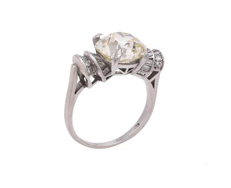 A diamond single stone ring, the old mine cut diamond weighing 5.00 carats within a four claw setting, to tapered baguette cu