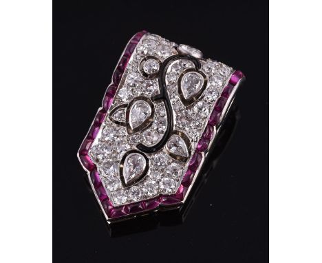 An Art Deco ruby and diamond clip brooch, circa 1930, the pierced rectangular panel with tapered end pavé set with old brilli
