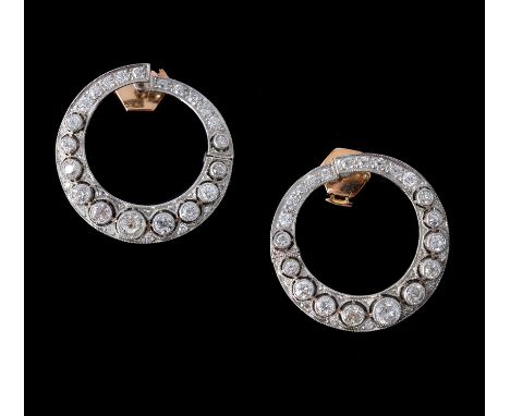 A pair of 1920s diamond crescent earrings, the pierced hooped panels set with graduated old brilliant cut and eight cut diamo