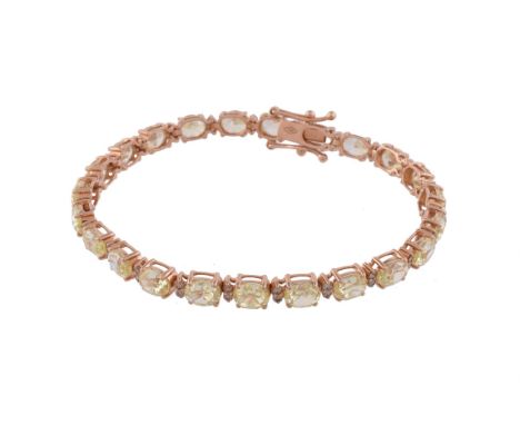 A yellow diamond and diamond tennis bracelet by Crivelli, the oval cut yellow diamonds stated to weigh 11.50 carats, interspa