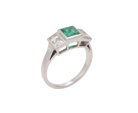 A five stone emerald and diamond ring, the central step cut emerald flanked by French cut diamonds, approximately 0.40 carats