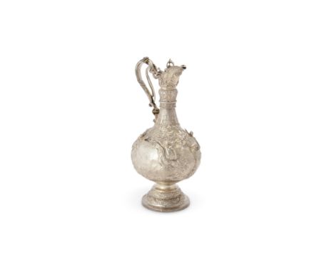 Y An Edwardian silver Armada pattern claret jug by Martin, Hall & Co., Sheffield 1905, of typical form, with an open scrollwo