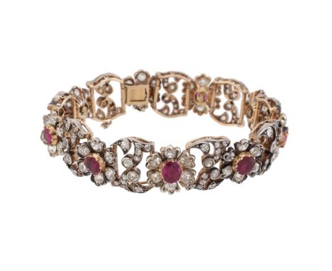 An early 20th century Burma ruby and diamond floral bracelet, the flower head cluster panels each centred with an oval cut Bu