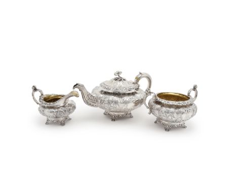 Y A William IV silver lobed circular three piece tea service, maker's mark IW (not traced), London 1833, the tea pot with a f