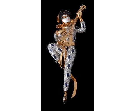 An enamelled sapphire and diamond harlequin brooch, the harlequin with enamelled face, hat and shoes, dancing whilst playing 