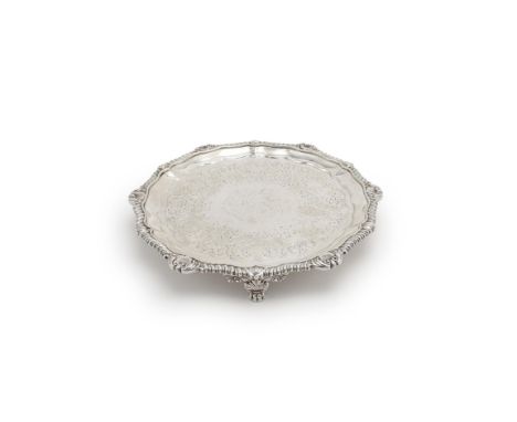 A late George III silver shaped circular salver by William Burwash, London 1817, with a gadroon and shell rim, engraved with 