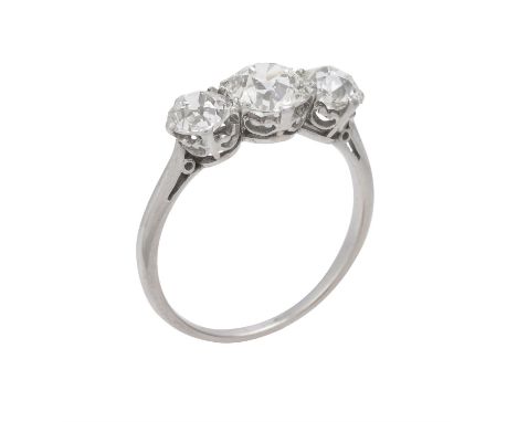 An early 20th century three stone diamond ring, the central old brilliant cut diamond estimated to weigh 1.27 carats, flanked