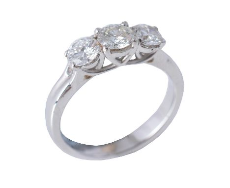 A diamond three stone ring, the graduated brilliant cut diamonds in four claw settings, approximately 1.04 carats total, the 