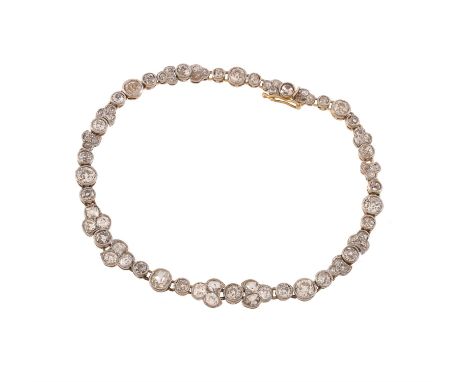 An early 20th century diamond bracelet, the graduated millegrain set old cut diamonds with shaped millegrained links between,