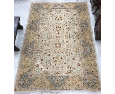 A Persian carpet, the central panel set with all over foliate decoration on cream ground within a stepped cream, green, yello