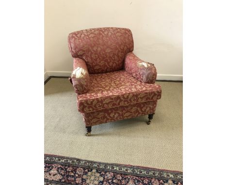 A George Smith 'Howard' style upholstered sofa on turned and ringed legs to brass caps and castors, together with a matching 