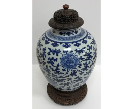 A 19th Century Chinese blue and white vase with all over foliate and floral decoration, 32.5 cm high excluding base and lid, 