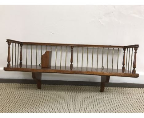 A 19th Century brass and walnut wall mounted book trough with adjustable spacer and bracket supports, 76 cm wide x 19 cm deep