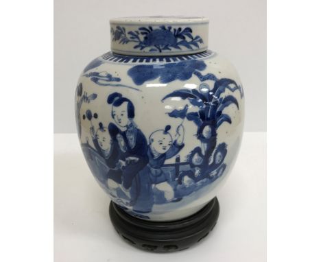 A 19th Century Chinese blue and white ginger jar and cover decorated with figures playing music and dancing in a garden setti