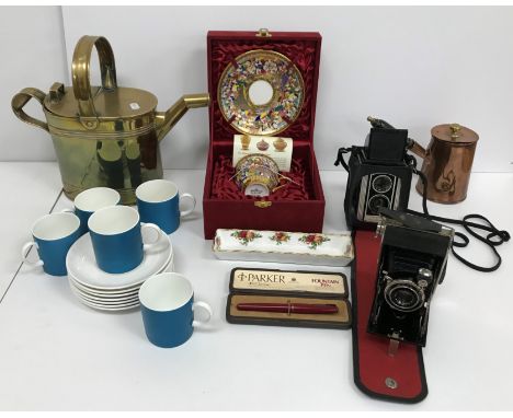 A box containing a Joseph Sankey brass watering, a set of five Susie Cooper design Wedgwood coffee cans and seven saucers, a 