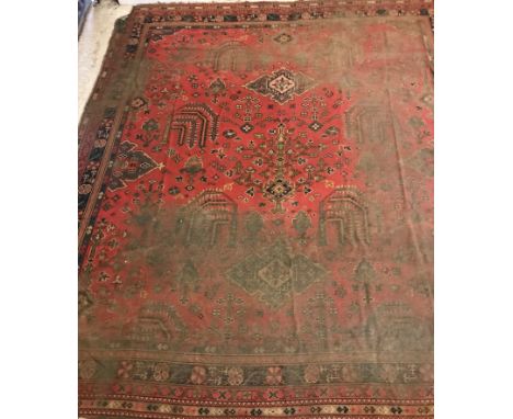An Ushak design carpet, the central panel set with stylised foliate decoration on a red ground, within a stepped red and blue